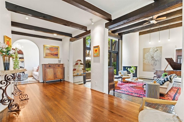 50 Albion St, Denver, CO 80220 - living room with wood-type flooring, arched walkways, a ceiling fan, beam ceiling, and a baseboard heating unit