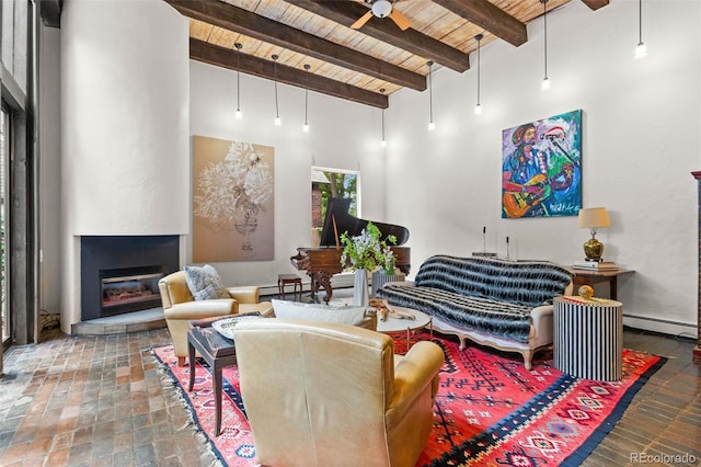 50 Albion St, Denver, CO 80220 - living area featuring a wooden ceiling with exposed beams, a ceiling fan, a baseboard radiator, a glass covered fireplace, and a towering ceiling