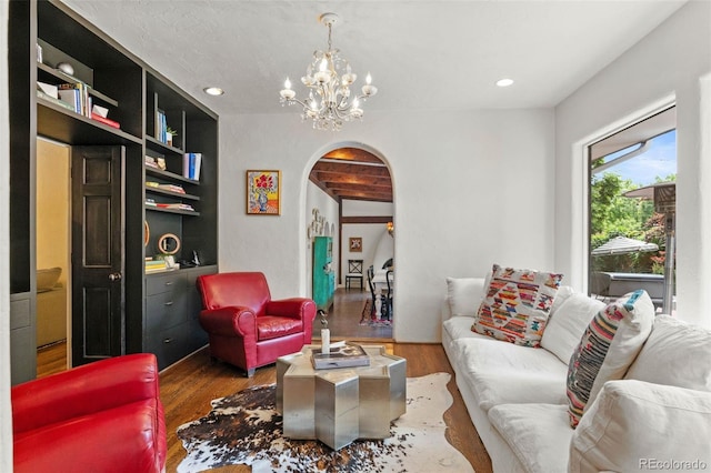 50 Albion St, Denver, CO 80220 - living area featuring arched walkways, wood finished floors, a chandelier, and recessed lighting