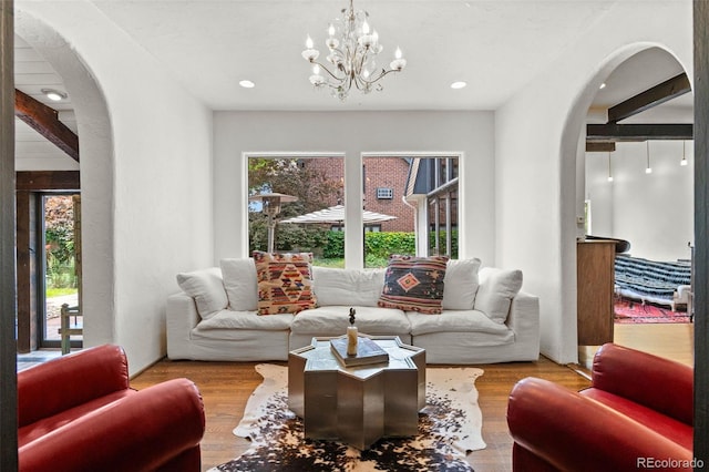50 Albion St, Denver, CO 80220 - living room with arched walkways, a chandelier, wood finished floors, and recessed lighting