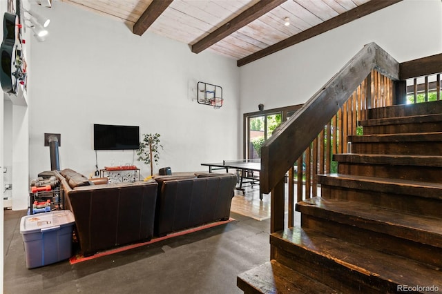 50 Albion St, Denver, CO 80220 - living room featuring a wooden ceiling with exposed beams, concrete floors, stairway, and a wood stove