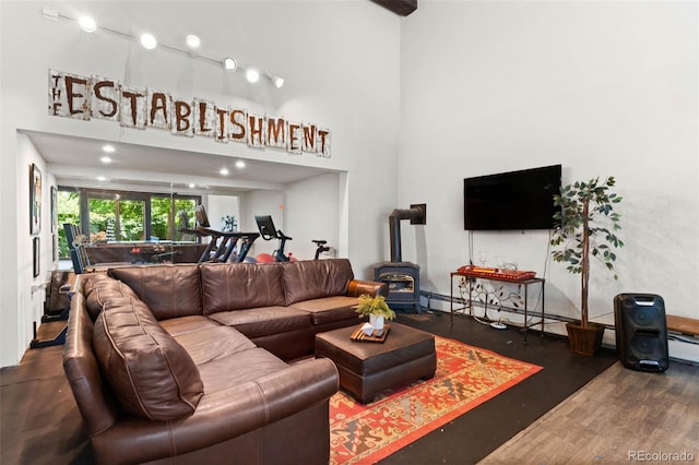 50 Albion St, Denver, CO 80220 - living room with a wood stove, a high ceiling, and wood finished floors