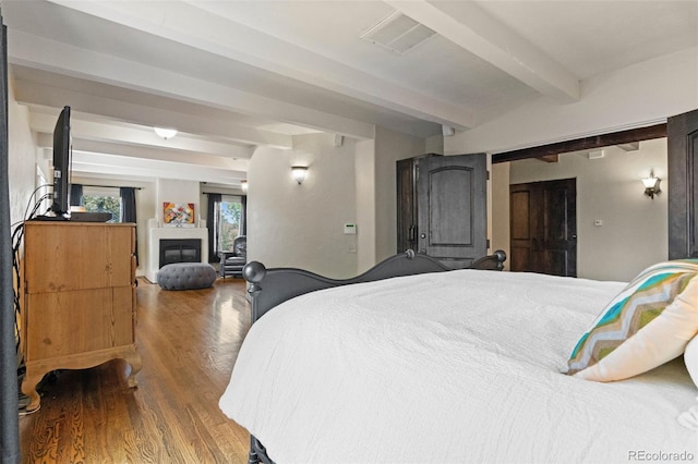 50 Albion St, Denver, CO 80220 - bedroom with beamed ceiling, wood finished floors, and a glass covered fireplace