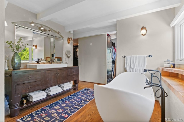 50 Albion St, Denver, CO 80220 - bathroom with beamed ceiling, a soaking tub, wood finished floors, and vanity