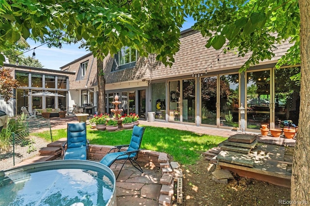50 Albion St, Denver, CO 80220 - rear view of house featuring a patio area, mansard roof, and a shingled roof