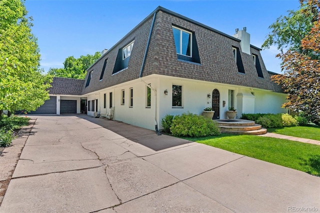 50 Albion St, Denver, CO 80220 - view of front of house featuring a shingled roof, mansard roof, a chimney, a front yard, and stucco siding