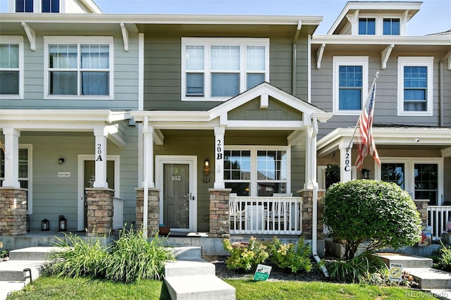 15612 E 96th Way Unit 20B, Commerce City, CO 80022 - townhome / multi-family property with a porch and stone siding