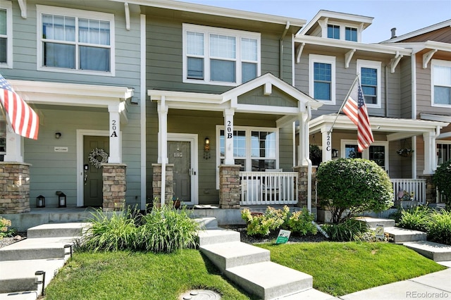 15612 E 96th Way Unit 20B, Commerce City, CO 80022 - view of front of home featuring covered porch and stone siding