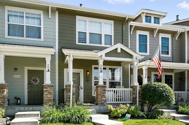 15612 E 96th Way Unit 20B, Commerce City, CO 80022 - view of property featuring covered porch and stone siding