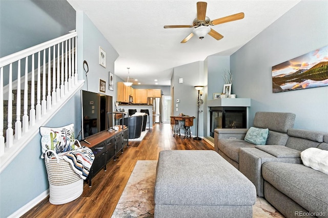 15612 E 96th Way Unit 20B, Commerce City, CO 80022 - living room featuring wood finished floors, ceiling fan, stairs, and a multi sided fireplace