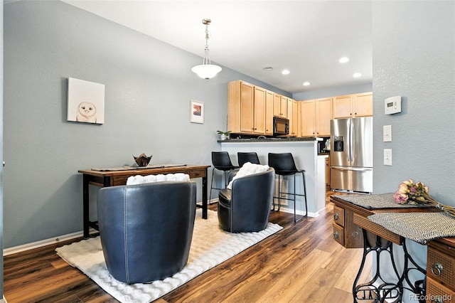 15612 E 96th Way Unit 20B, Commerce City, CO 80022 - living area with wood finished floors, recessed lighting, and a textured wall