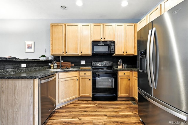 15612 E 96th Way Unit 20B, Commerce City, CO 80022 - kitchen featuring black appliances, light brown cabinetry, wood finished floors, dark countertops, and recessed lighting