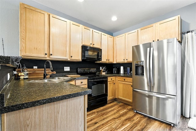 15612 E 96th Way Unit 20B, Commerce City, CO 80022 - kitchen with black appliances, light brown cabinets, dark countertops, wood finished floors, and recessed lighting