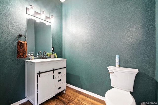 15612 E 96th Way Unit 20B, Commerce City, CO 80022 - bathroom with wood finished floors, vanity, and a textured wall