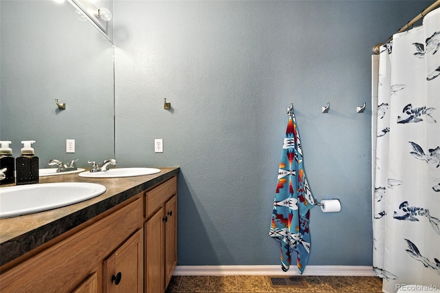 15612 E 96th Way Unit 20B, Commerce City, CO 80022 - bathroom with double vanity and baseboards