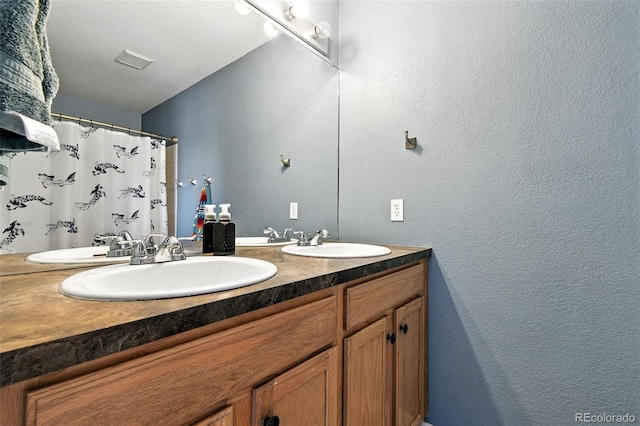 15612 E 96th Way Unit 20B, Commerce City, CO 80022 - full bathroom with double vanity, a textured wall, and curtained shower