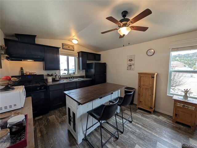 10795 County Road 197a Unit 137, Nathrop, CO 81236 - kitchen featuring freestanding refrigerator, white microwave, butcher block counters, range with gas stovetop, and vaulted ceiling