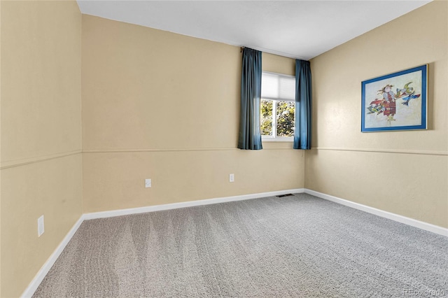 unfurnished room with visible vents, carpet flooring, and baseboards