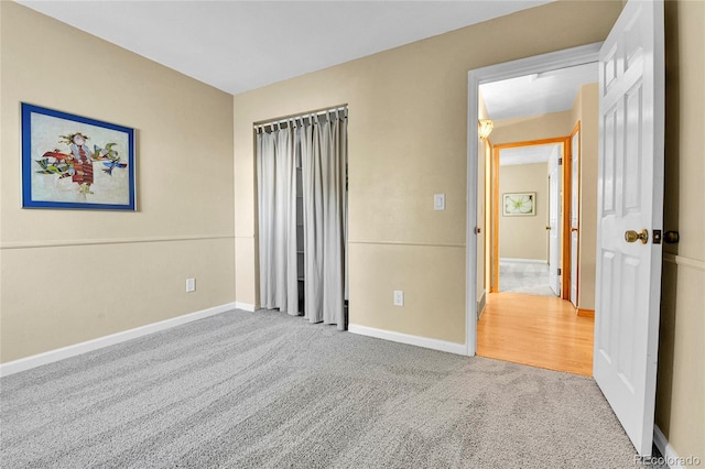 unfurnished bedroom with carpet flooring and baseboards