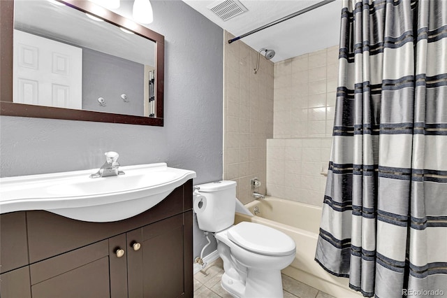bathroom featuring vanity, shower / tub combo with curtain, a textured wall, toilet, and visible vents