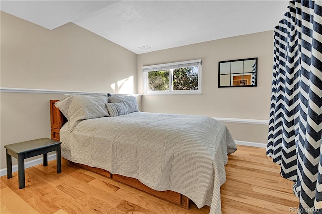 bedroom featuring baseboards, visible vents, and light wood-type flooring