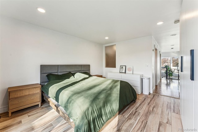 bedroom with recessed lighting and light wood-type flooring