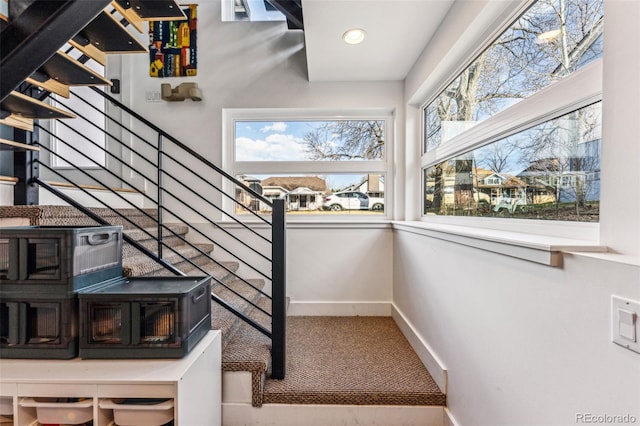 stairs with recessed lighting and baseboards