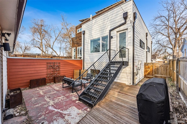 back of property with a deck and a fenced backyard