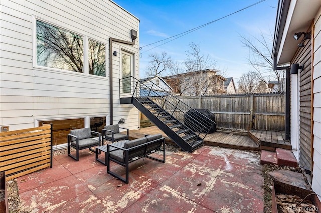 view of patio with a grill, a wooden deck, and fence