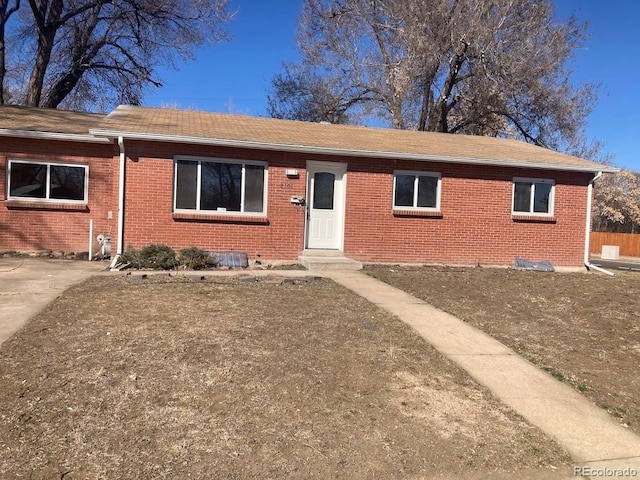 single story home with entry steps and brick siding