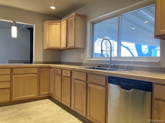 kitchen with light brown cabinetry, stainless steel dishwasher, a sink, and recessed lighting