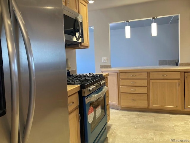 kitchen with appliances with stainless steel finishes, light countertops, and light brown cabinets