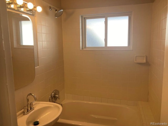 bathroom with tub / shower combination and a sink