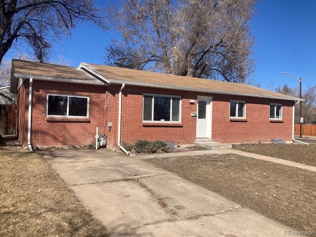 single story home featuring brick siding and fence