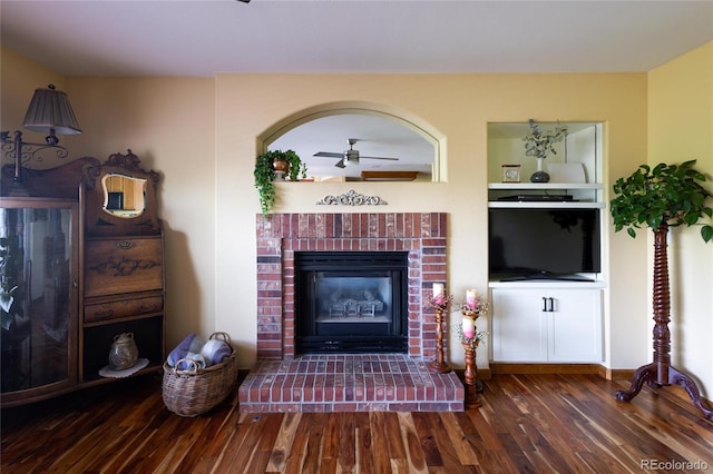 10218 Woodrose Ct, Highlands Ranch, CO 80129 - living area featuring wood finished floors, a brick fireplace, and a ceiling fan