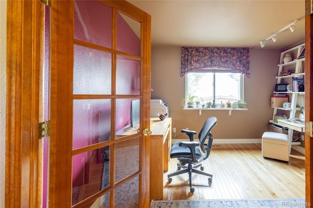 10218 Woodrose Ct, Highlands Ranch, CO 80129 - home office featuring rail lighting, wood finished floors, and baseboards