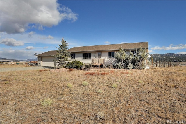 ranch-style house with a deck with mountain view