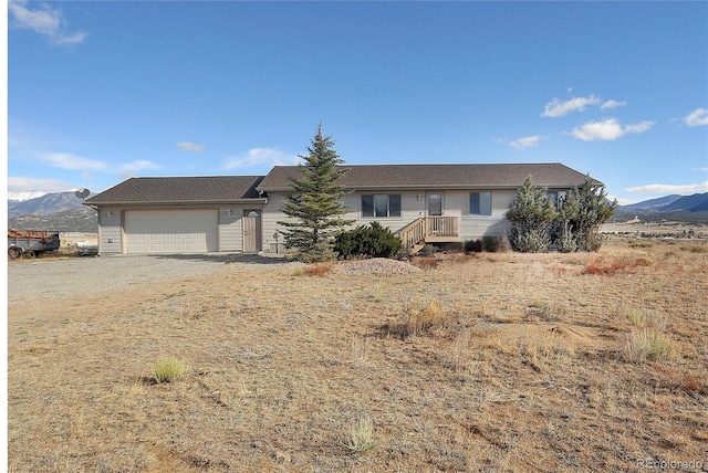 ranch-style house with a mountain view and a garage