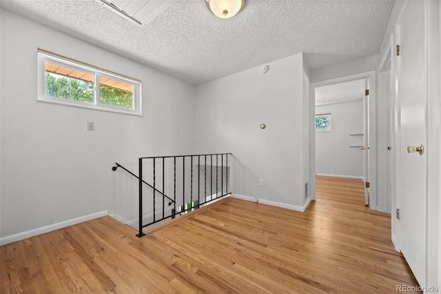 1844 S Pontiac Way, Denver, CO 80224 - hallway with an upstairs landing, a textured ceiling, light wood-style floors, and baseboards