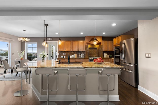1983 Candleglow St, Castle Rock, CO 80109 - kitchen with stainless steel appliances, dark wood finished floors, brown cabinets, decorative backsplash, and recessed lighting
