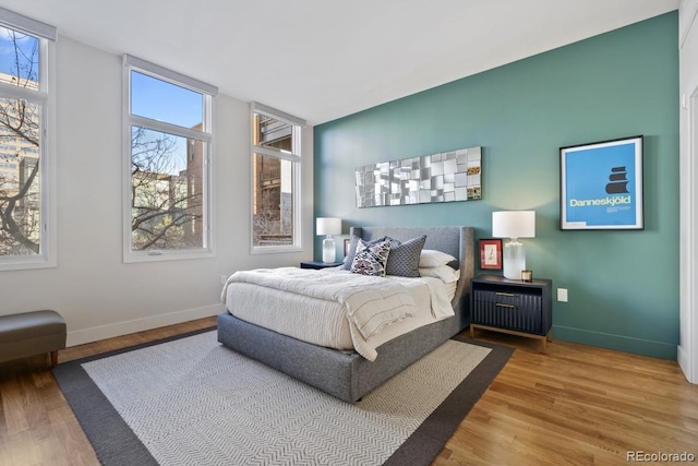 bedroom featuring wood finished floors and baseboards