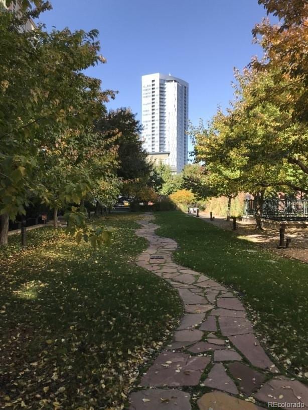 surrounding community featuring a view of city and a lawn