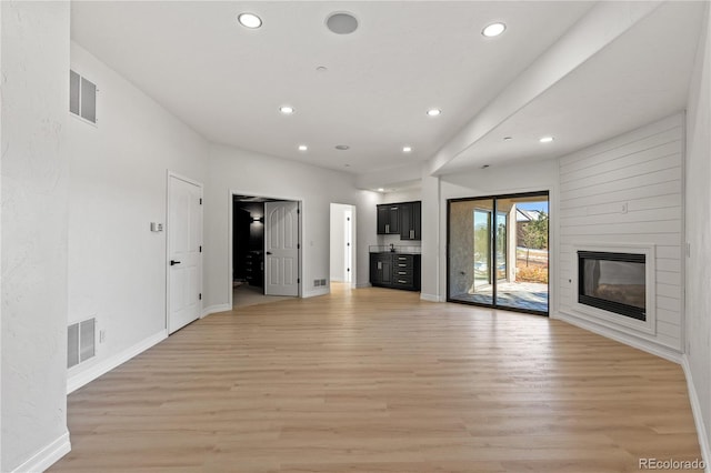 unfurnished living room featuring light wood-type flooring