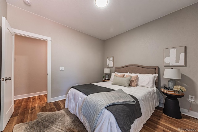 bedroom with dark hardwood / wood-style floors and vaulted ceiling