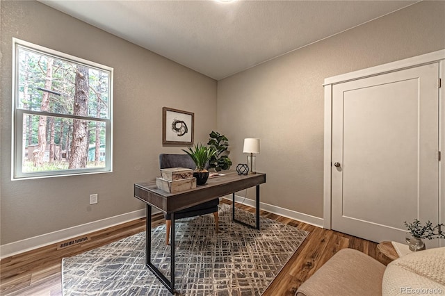 home office with hardwood / wood-style floors