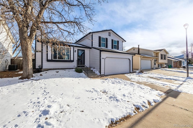 view of front of home featuring cooling unit and a garage