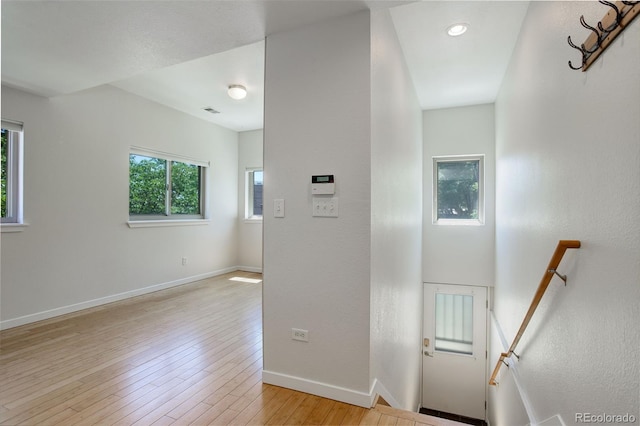 interior space featuring hardwood / wood-style floors, visible vents, and baseboards