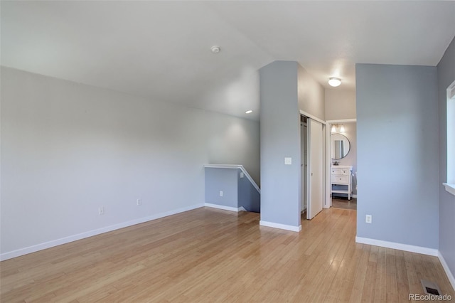 interior space featuring light wood finished floors and baseboards