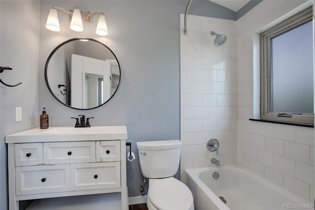 bathroom with bathtub / shower combination, vanity, and toilet