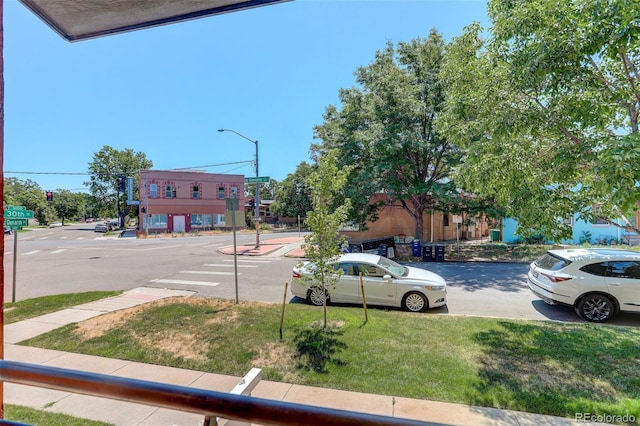 view of street featuring street lights, curbs, and sidewalks